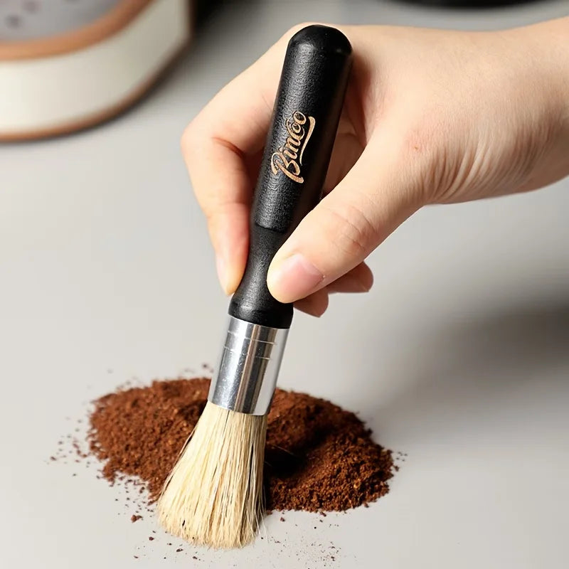 Crop Cafe coffee grinder cleaning brush featuring a sleek ergonomic black wooden handle, silver ferrule, and durable natural bristles.