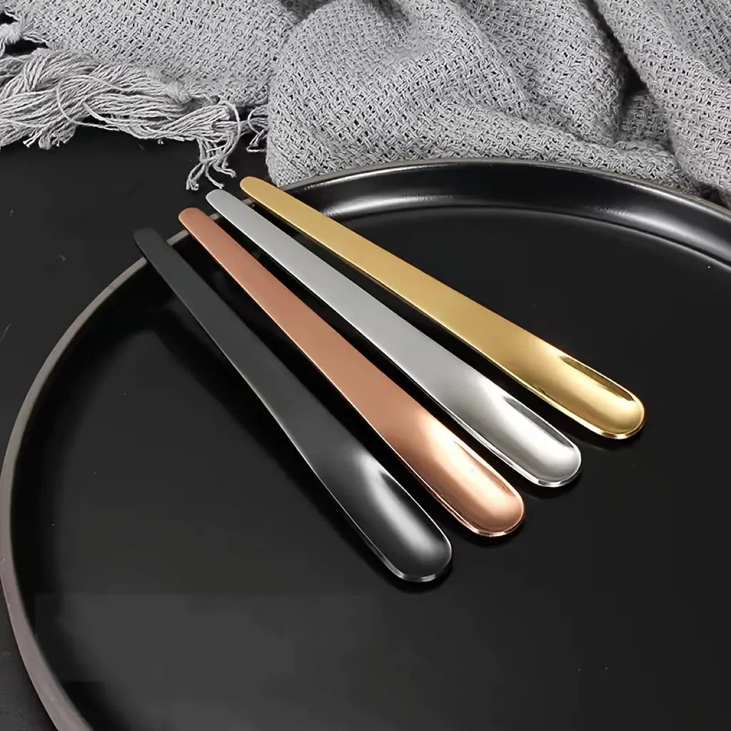 Four 410 Stainless Steel Espresso Spoons by Crop in matte black, silver, gold, and rose gold finishes.