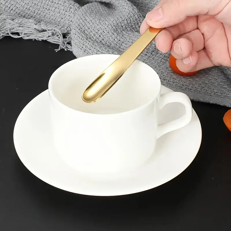 Four 410 Stainless Steel Espresso Spoons by Crop in matte black, silver, gold, and rose gold finishes.