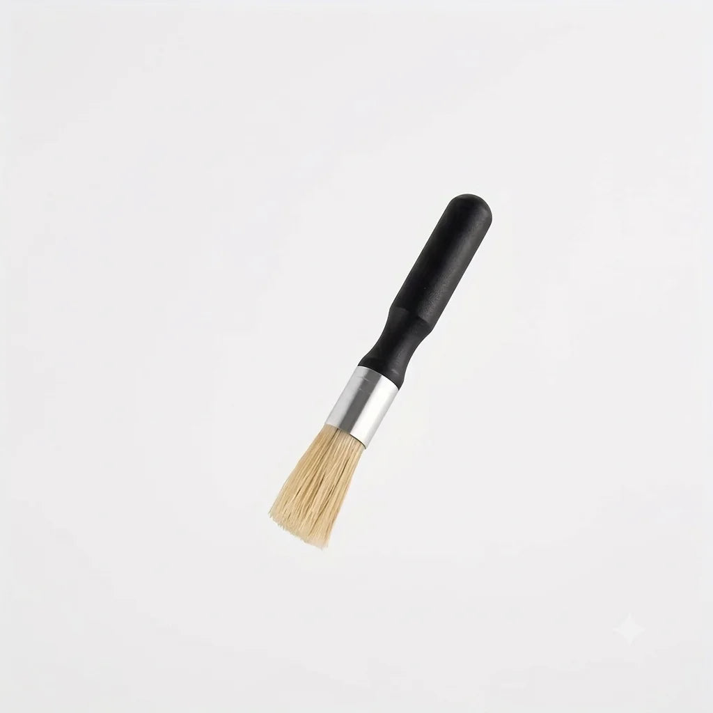 Crop Cafe coffee grinder cleaning brush featuring a sleek ergonomic black wooden handle, silver ferrule, and durable natural bristles.