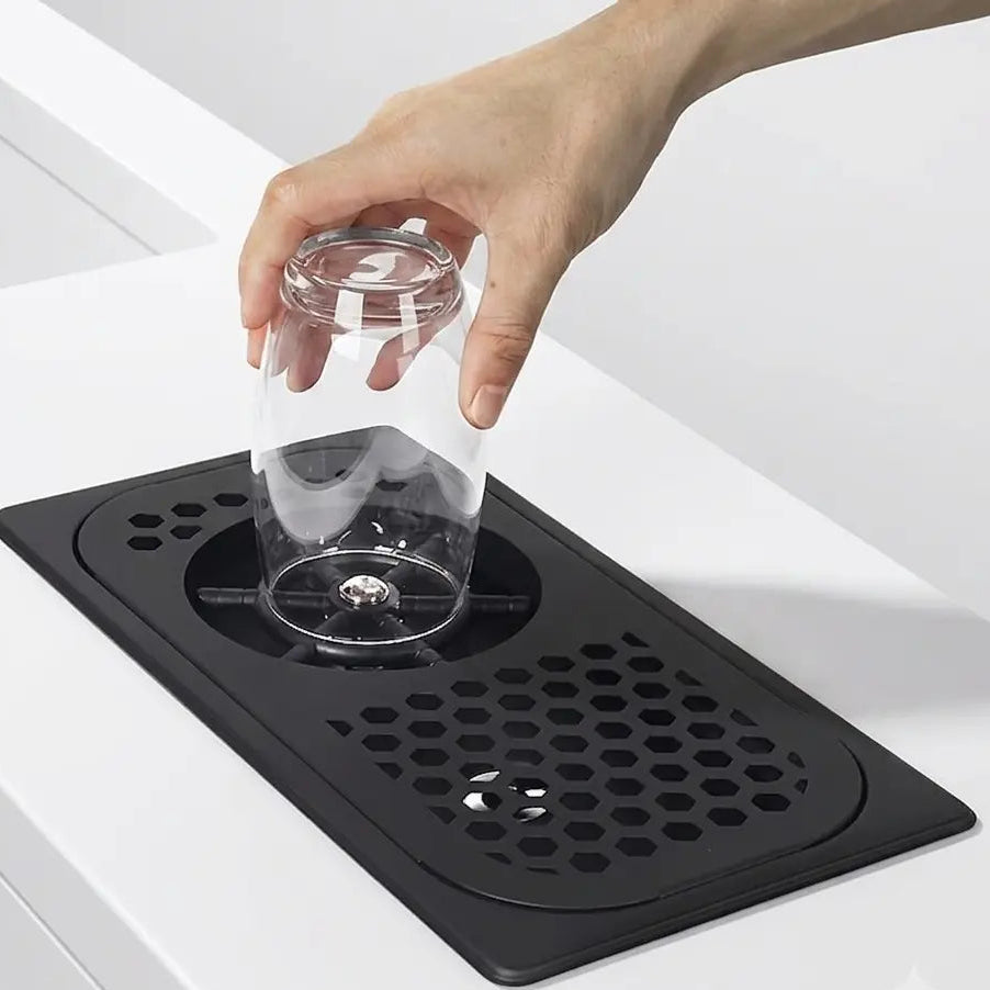 Crop Stainless Steel Rinser in matte black with a honeycomb drip tray and glass washer mechanism on a solid white background.